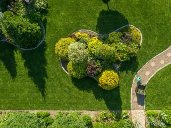 new-landscaping-arial-green-grass-bushes-trees-path